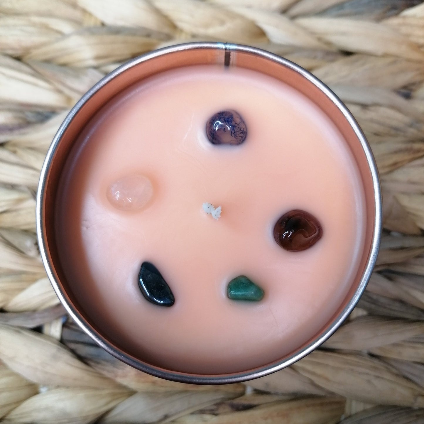 A strawberry and mango scented candle with crystal chips