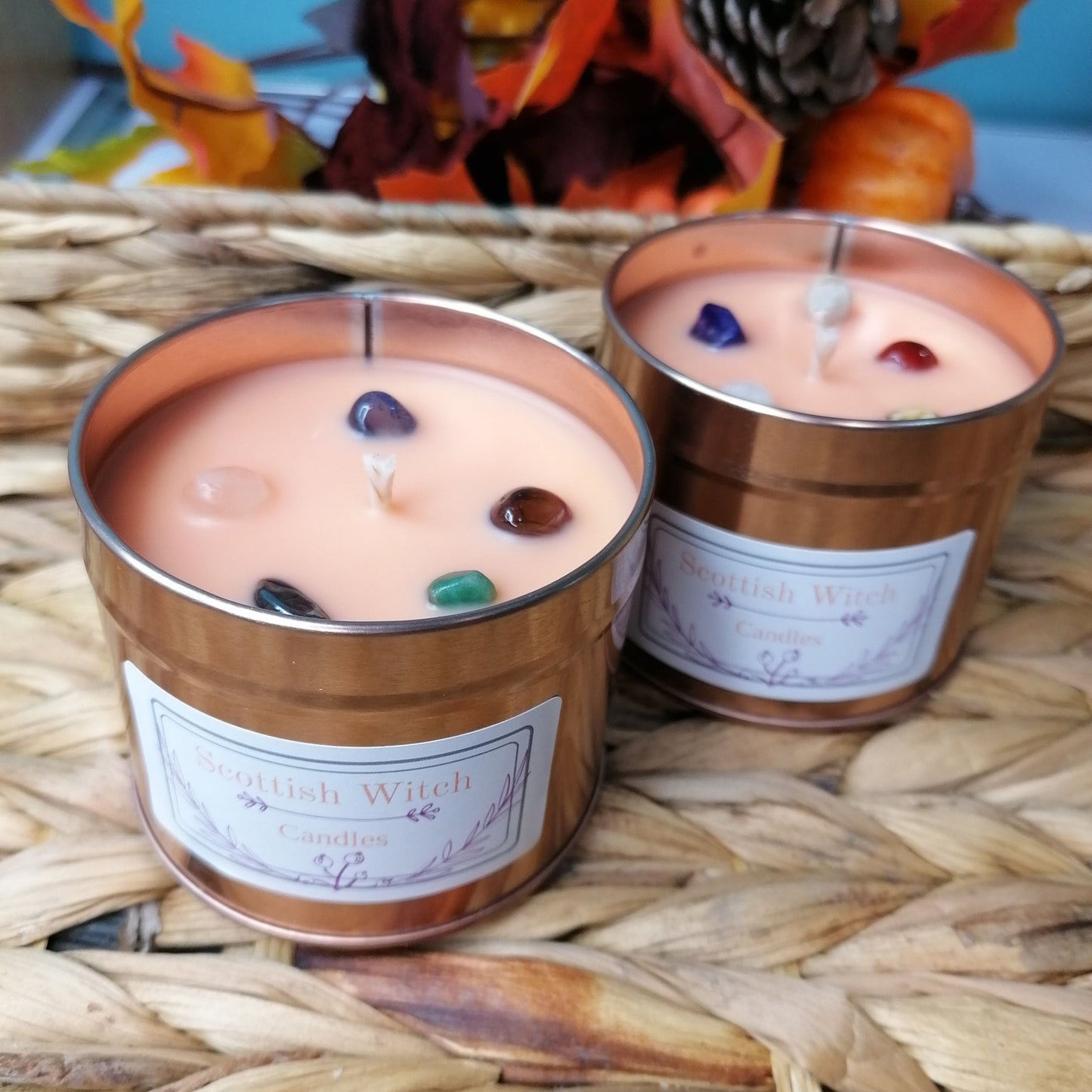 an orange candle with mixed crystal chips and a fruity strawberry and mango scent