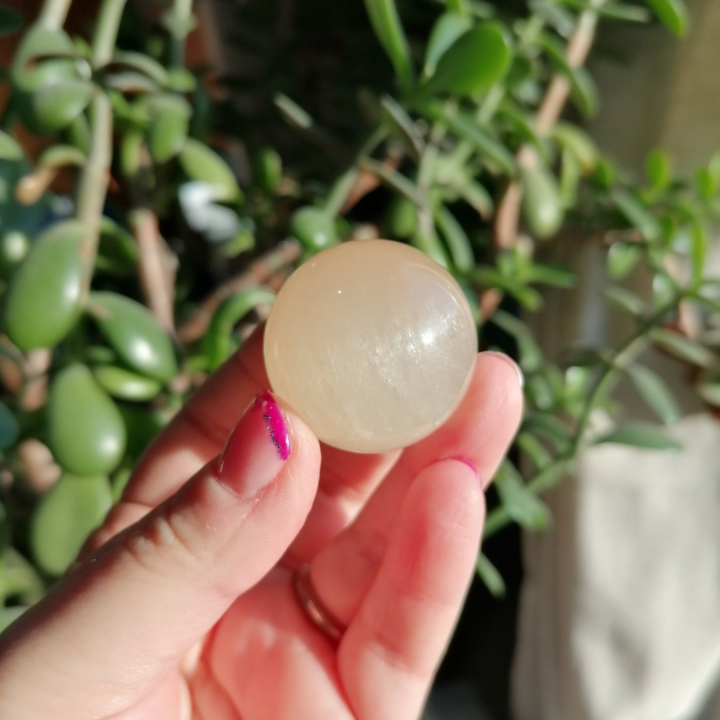 honey optical calcite sphere with rainbows, flashes, and asterisms