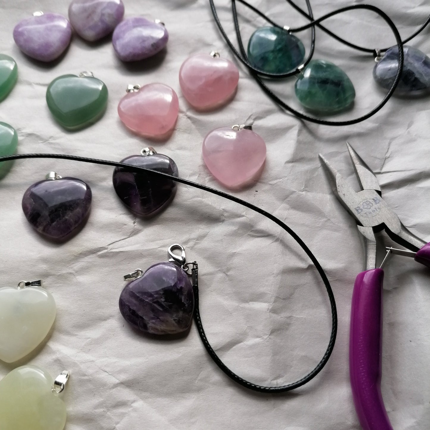 a selection of crystal heart pendants