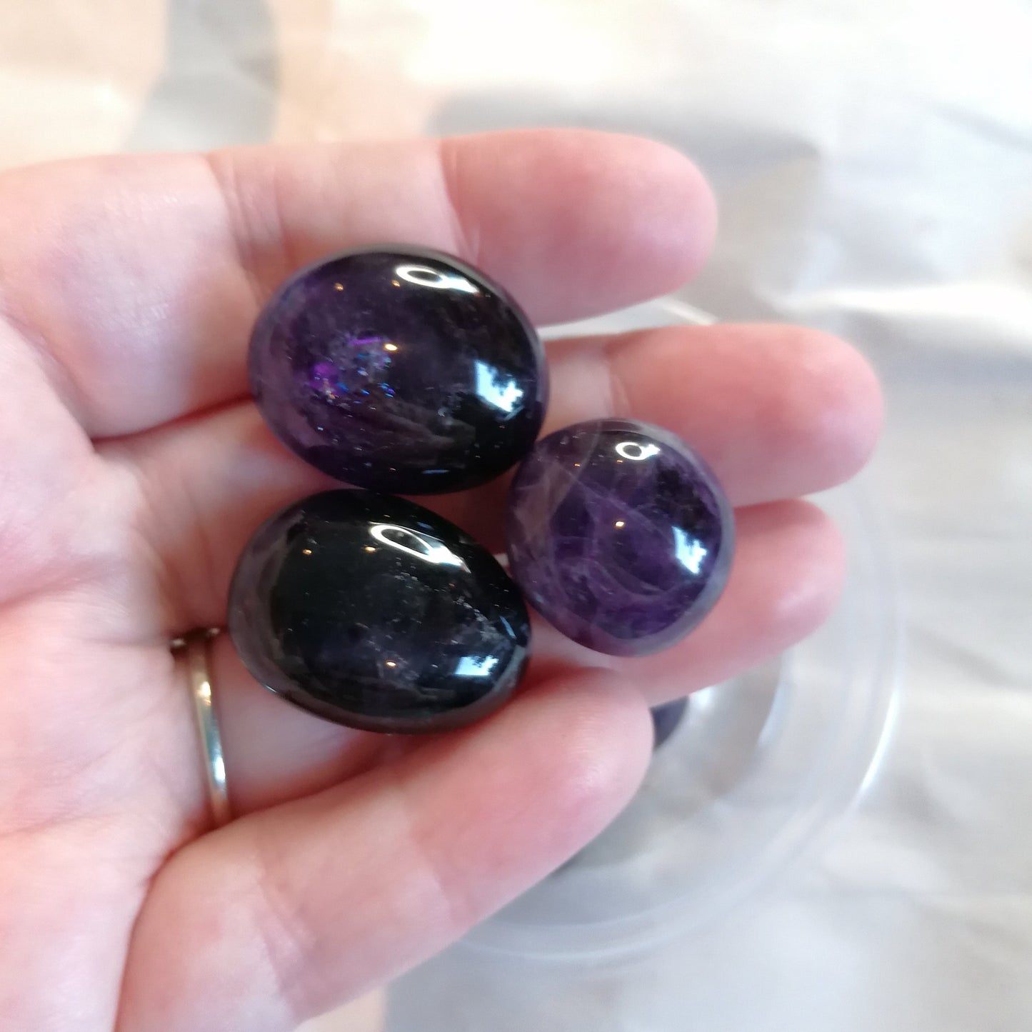 three purple amethyst tumblestones