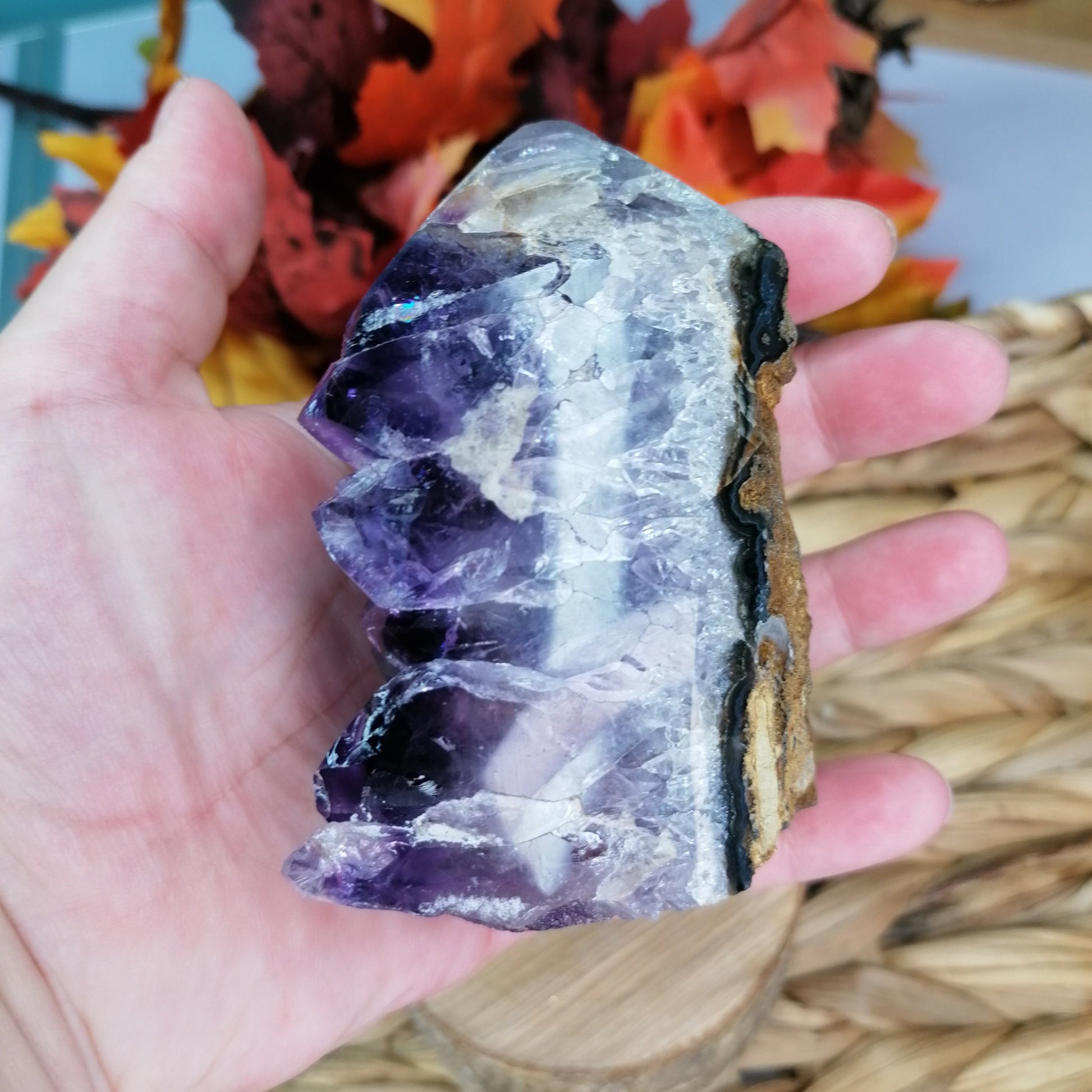 Side view of large amethyst druzy tower showing the purple and white banding