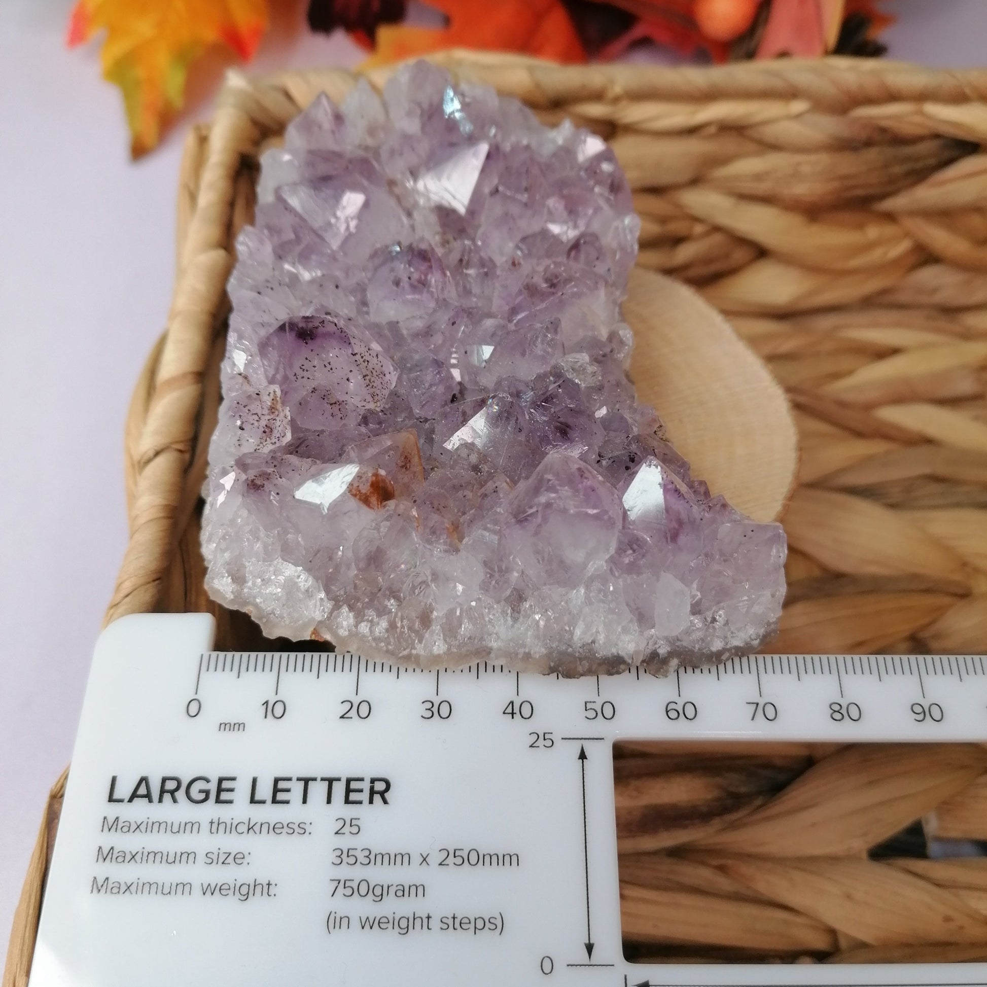 Purple and white amethyst cluster next to ruler to show a width of 70mm