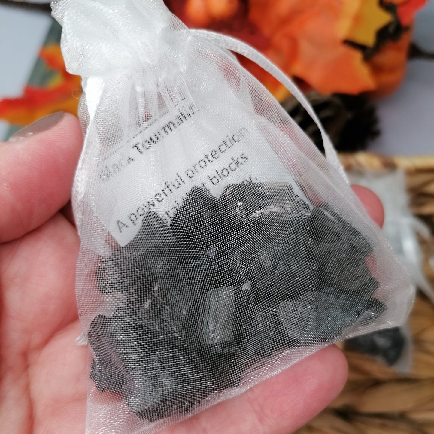 Black Tourmaline Crystal Chips in a white organza bag with description card