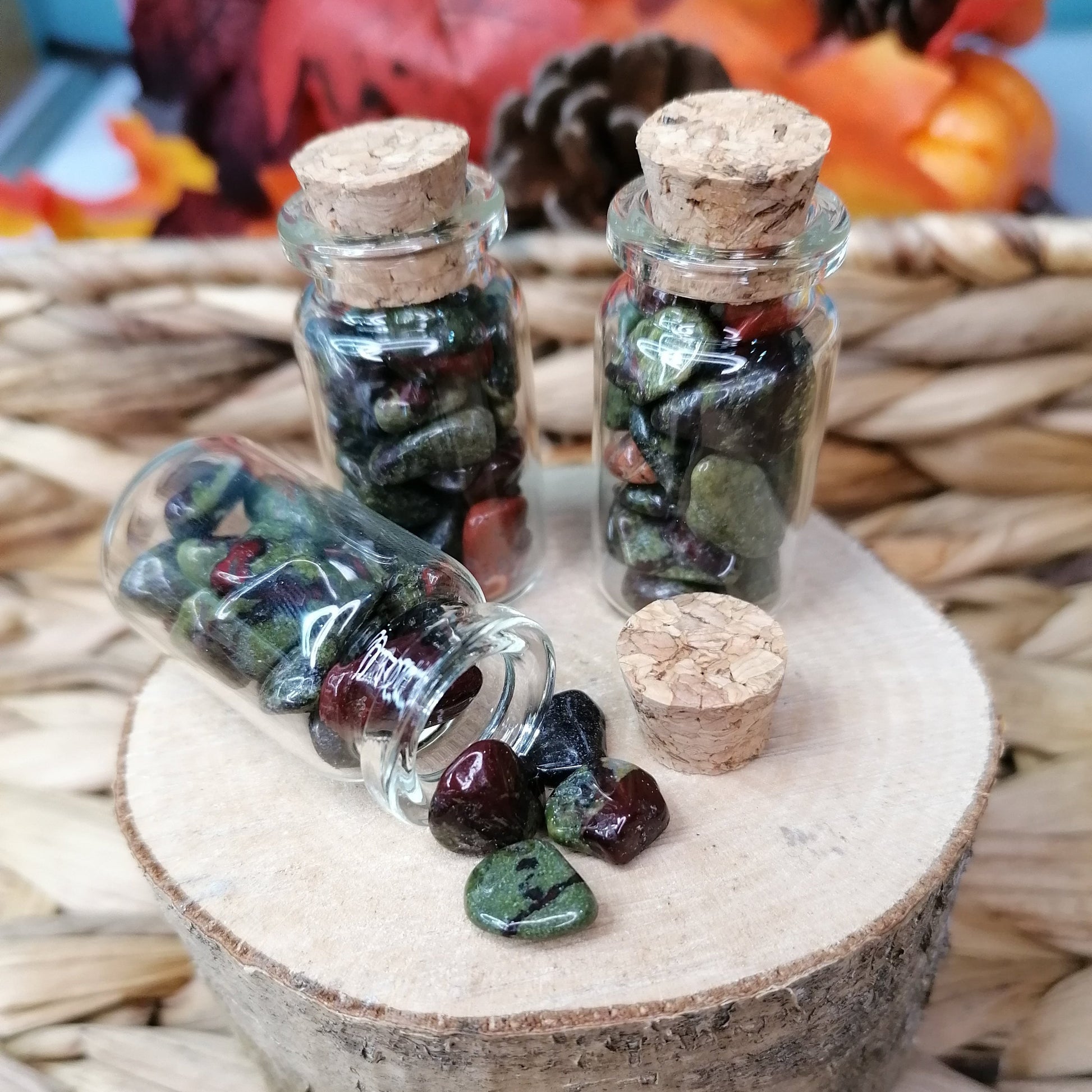 Green red and black dragon stone crystal chips in a bottle