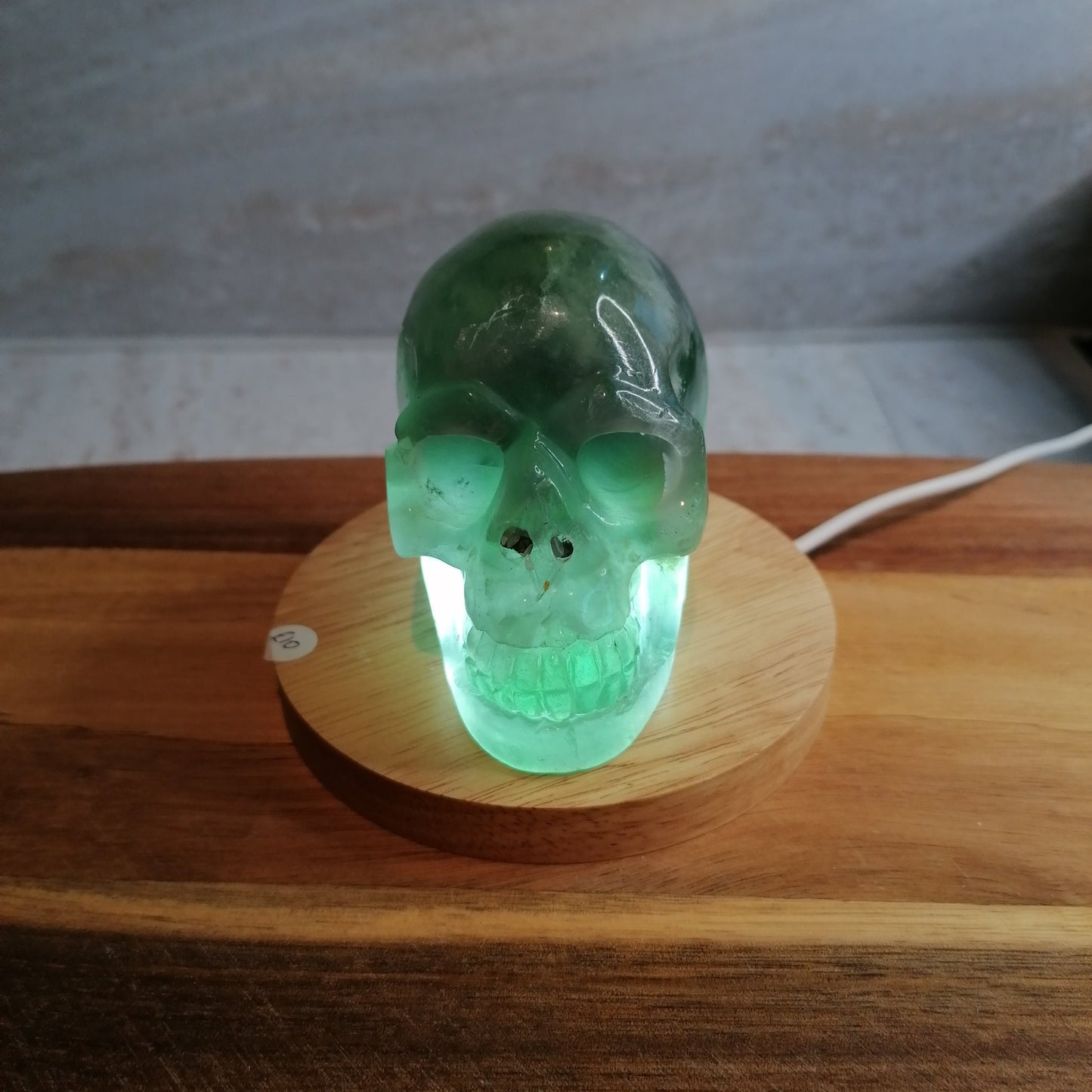 Dark Green Fluorite Skull on light pad