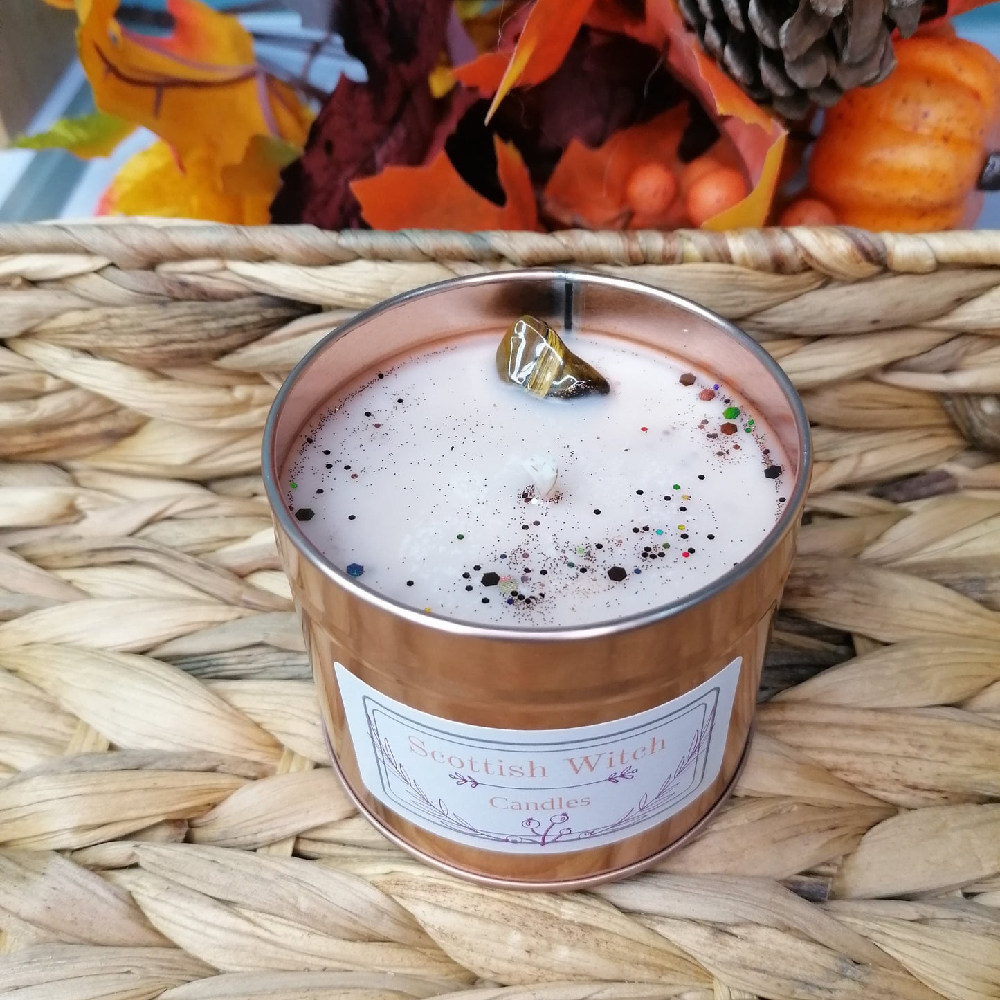 a Gingerbread scented candle with a light brown wax and decorated with a tigers eye crystal and glitter