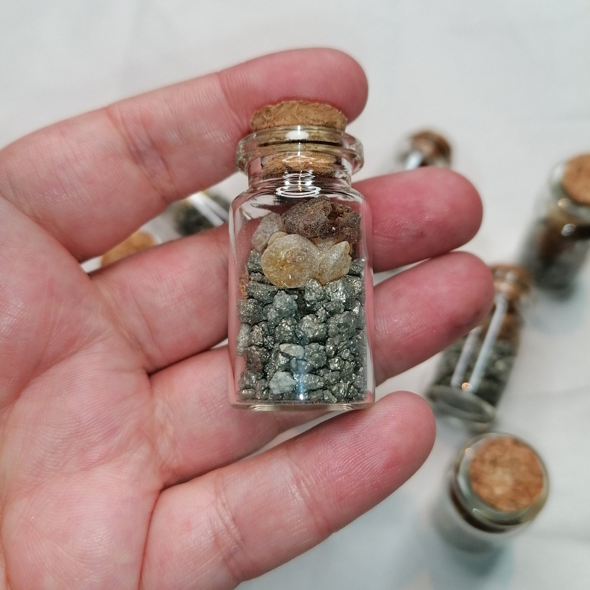 small glass bottle with pyrite gold,frankincense and myrrh resin