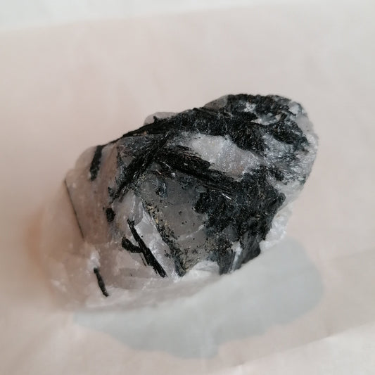 raw piece of white quartz with black tourmaline