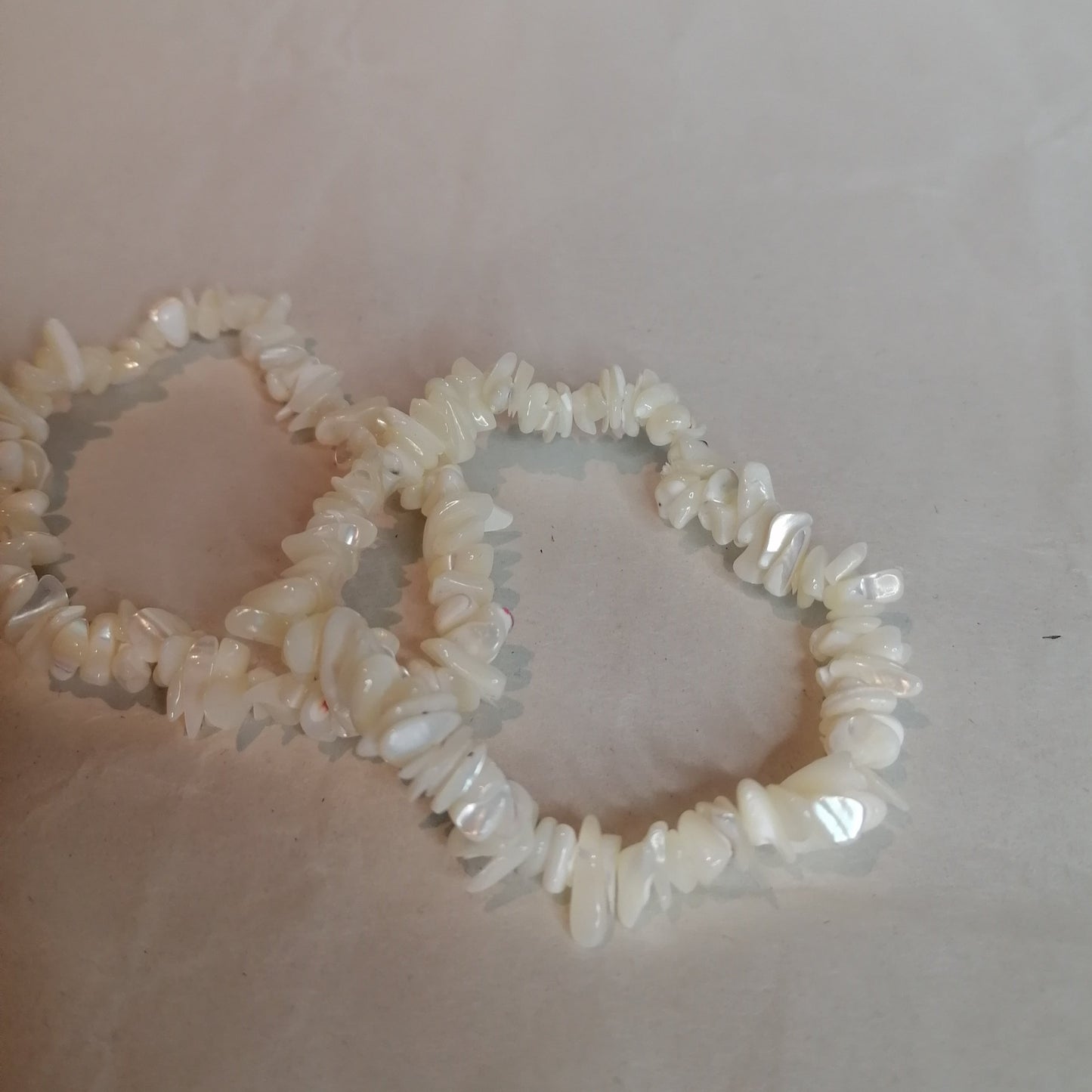 two white mother of pearl bracelets