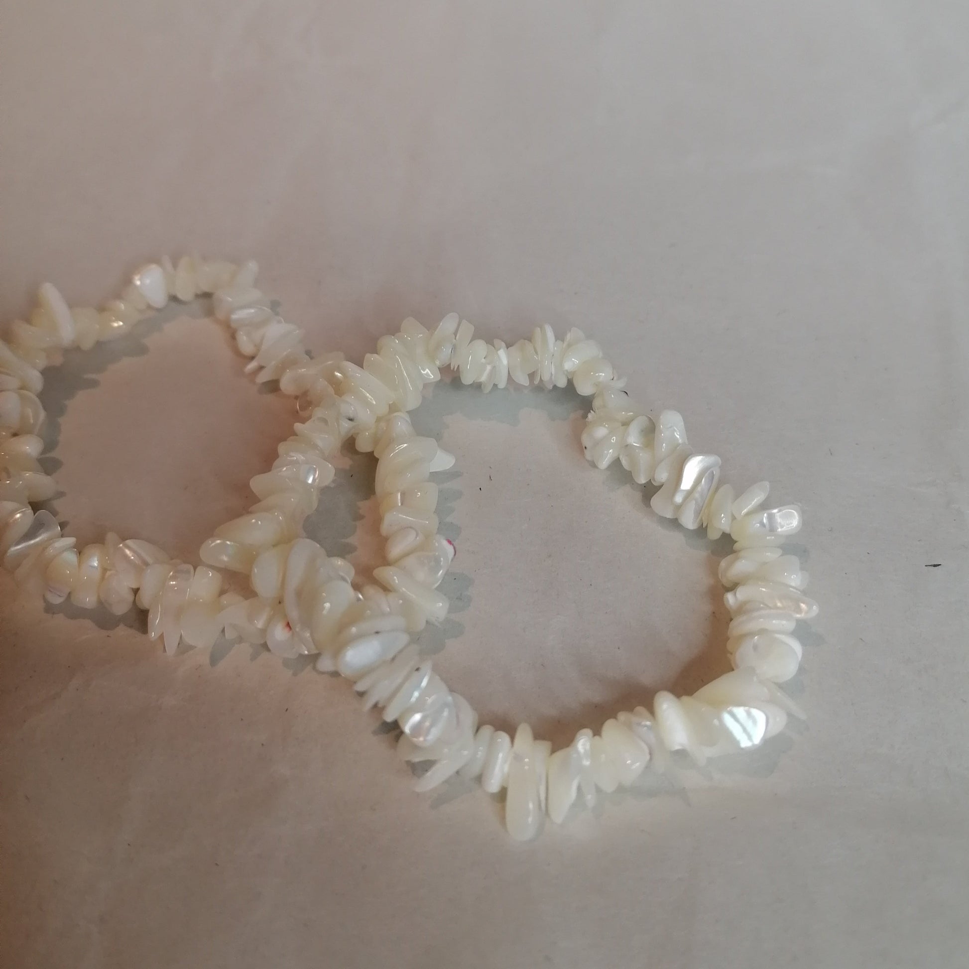 two white mother of pearl bracelets