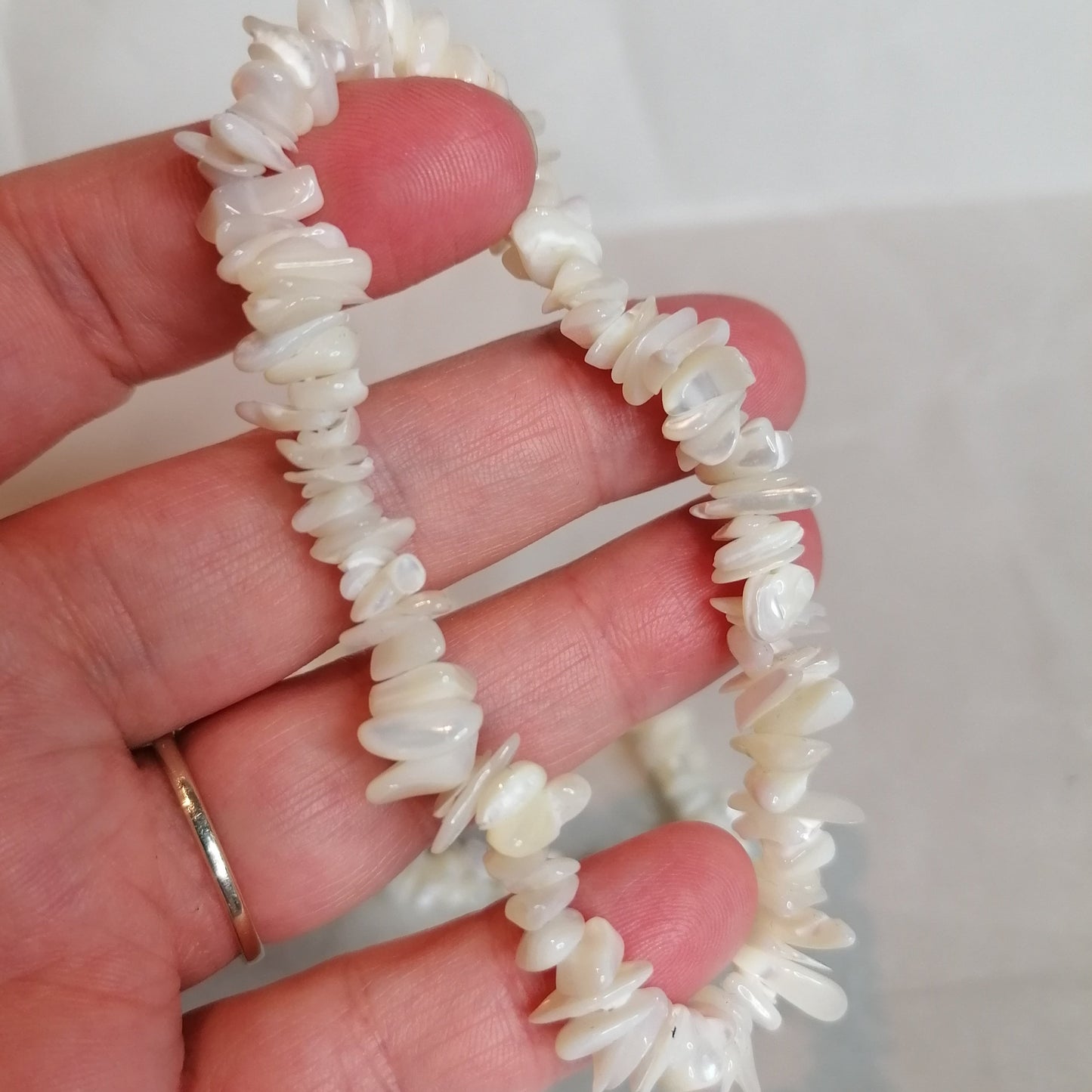 close up of a white mother of pearl chip bracelet