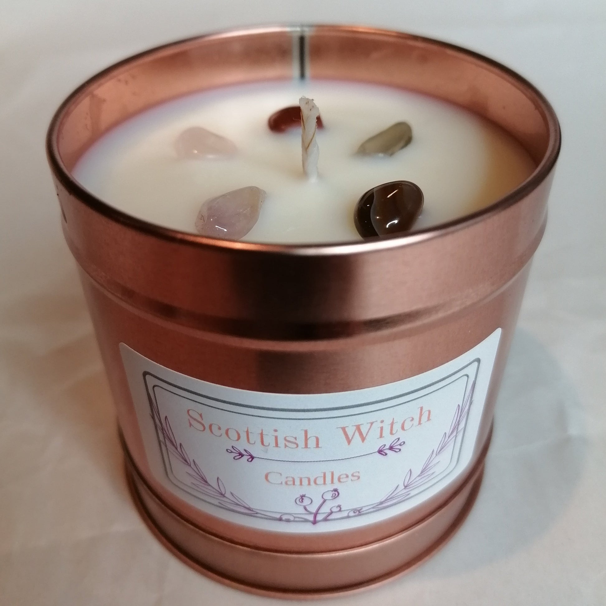 Unscented scottish witch crystal candle with white wax in a rose gold tin with mixed crystal chips