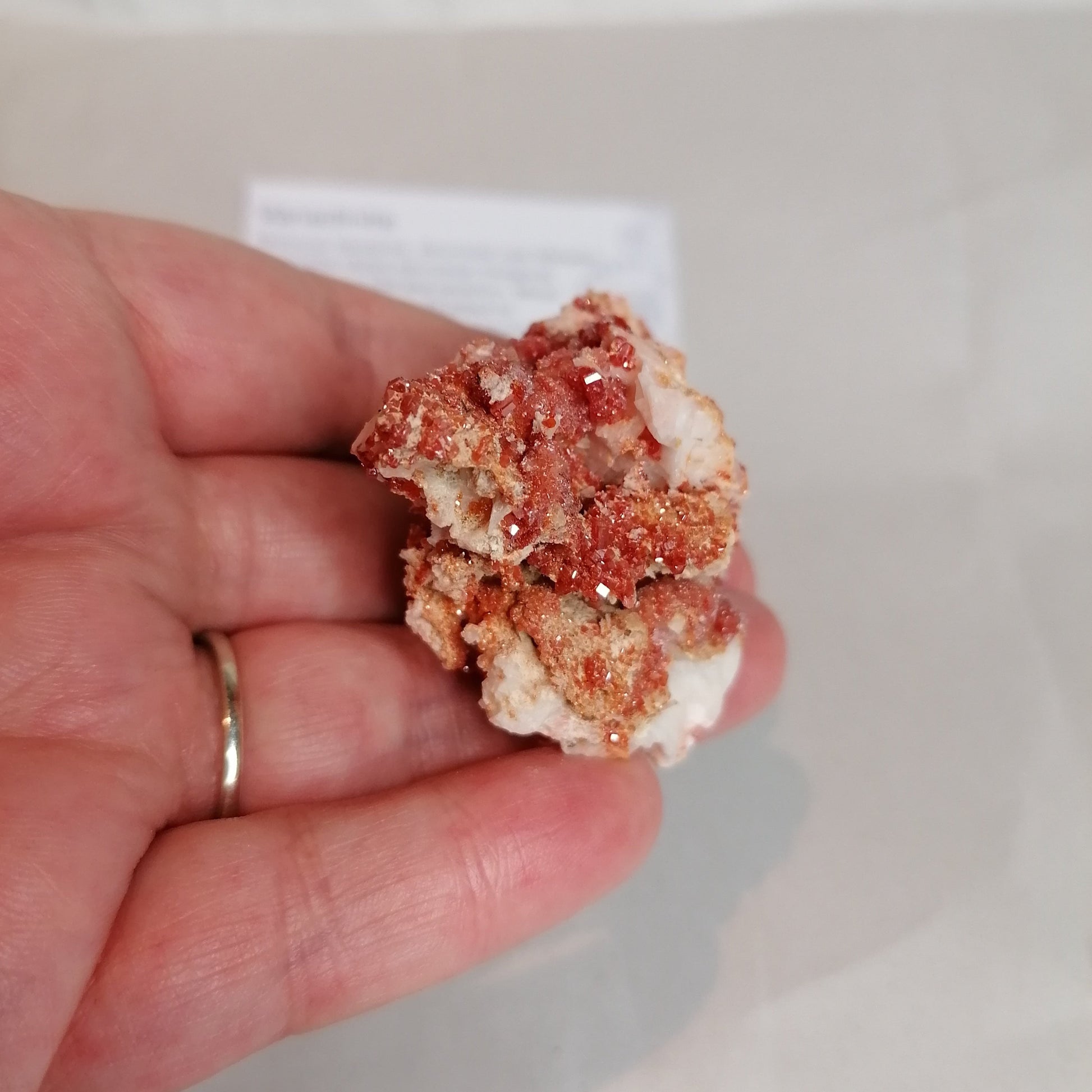 bright orange square crystals on a cream rock formation, vanadinite crystal specimen