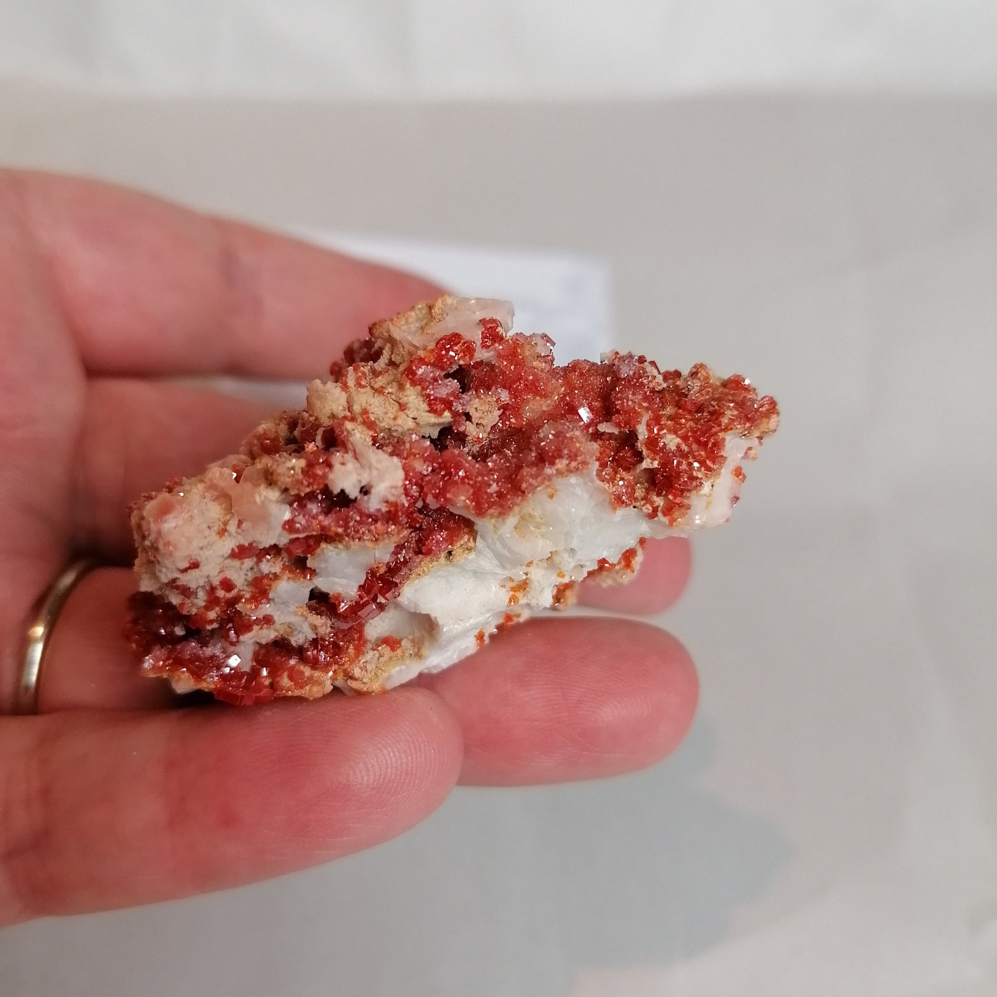 bright orange square crystals on a cream rock formation, vanadinite crystal specimen