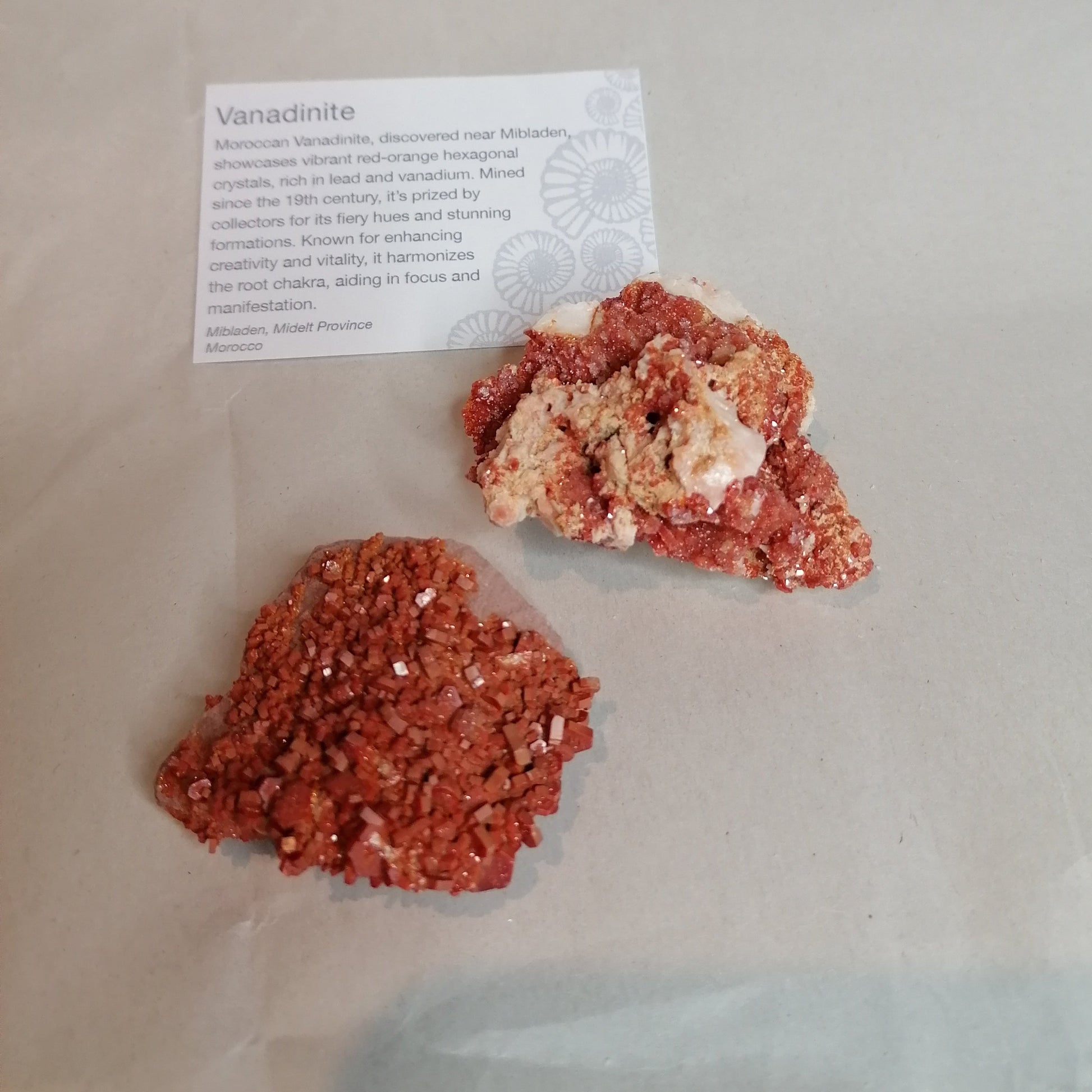 bright orange square crystals on a cream rock formation, vanadinite crystal specimen