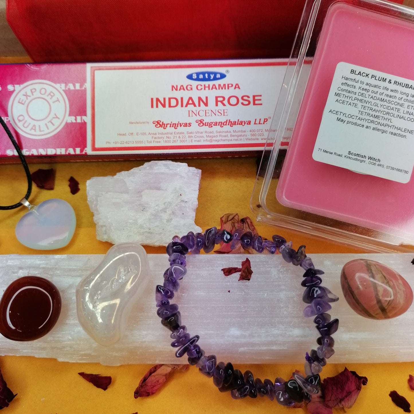 valentines gift box with a selection of colourful crystals an incense and a pink wax melt