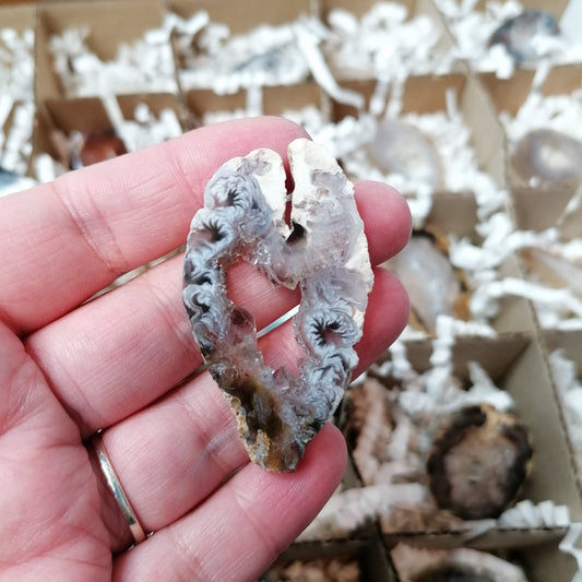 agate geode slice with white a grey swirls and a sparkly centre