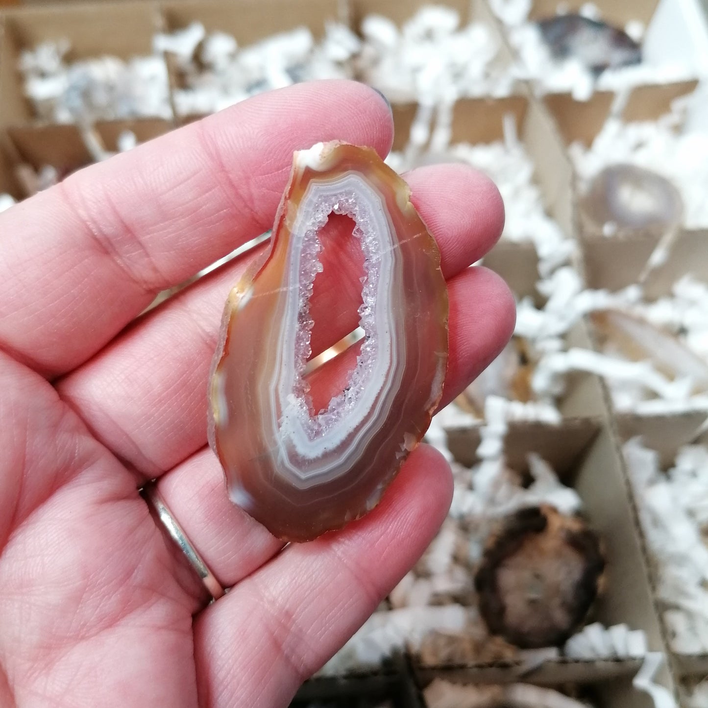 agate geode slice that is orange with a sparkly centre