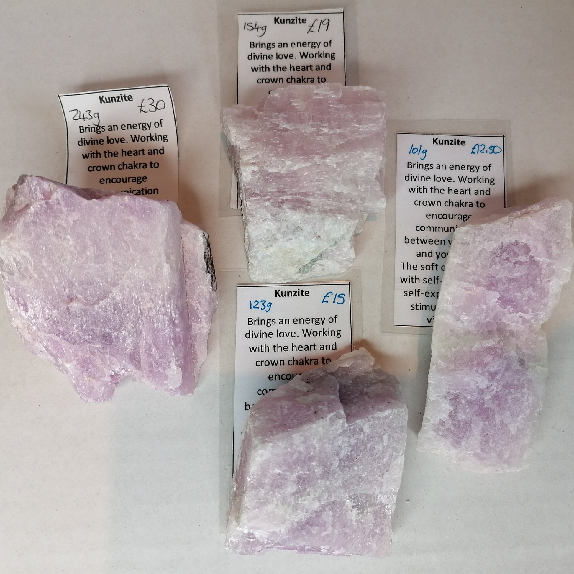 different sized pieces of purple kunzite in raw form