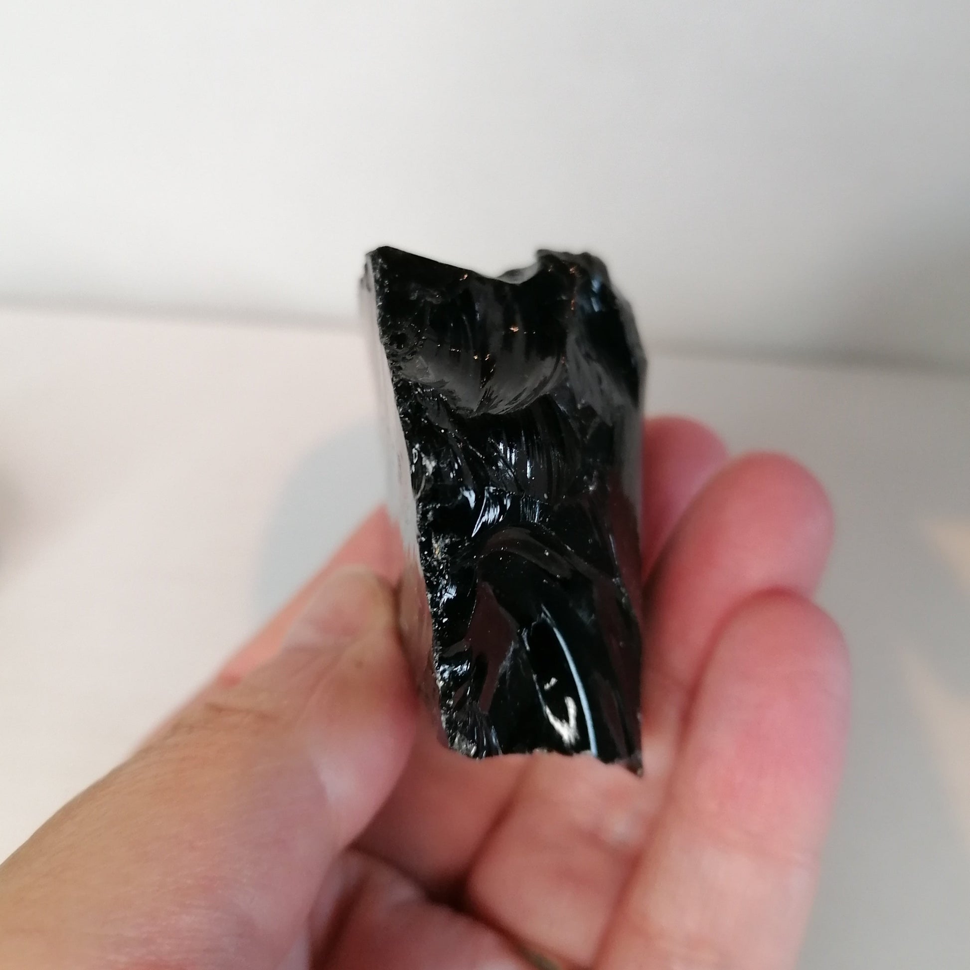 side view of the sharp black obsidian chunk