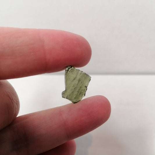 square piece of green moldavite