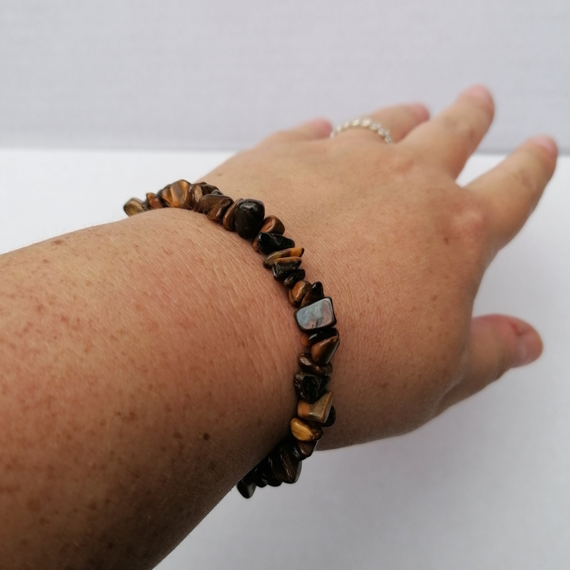 gold tigers eye chip bracelet on a wrist