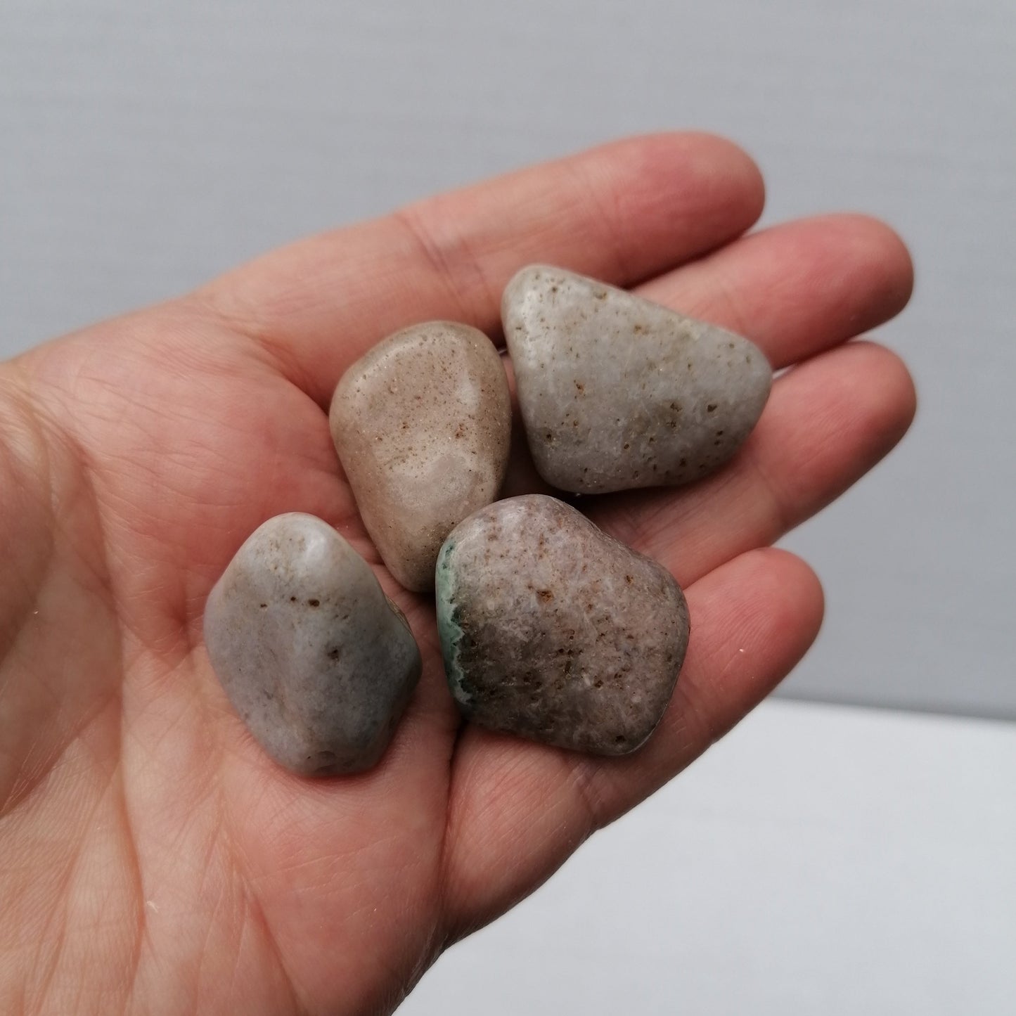 four pink amethyst tumbles up close