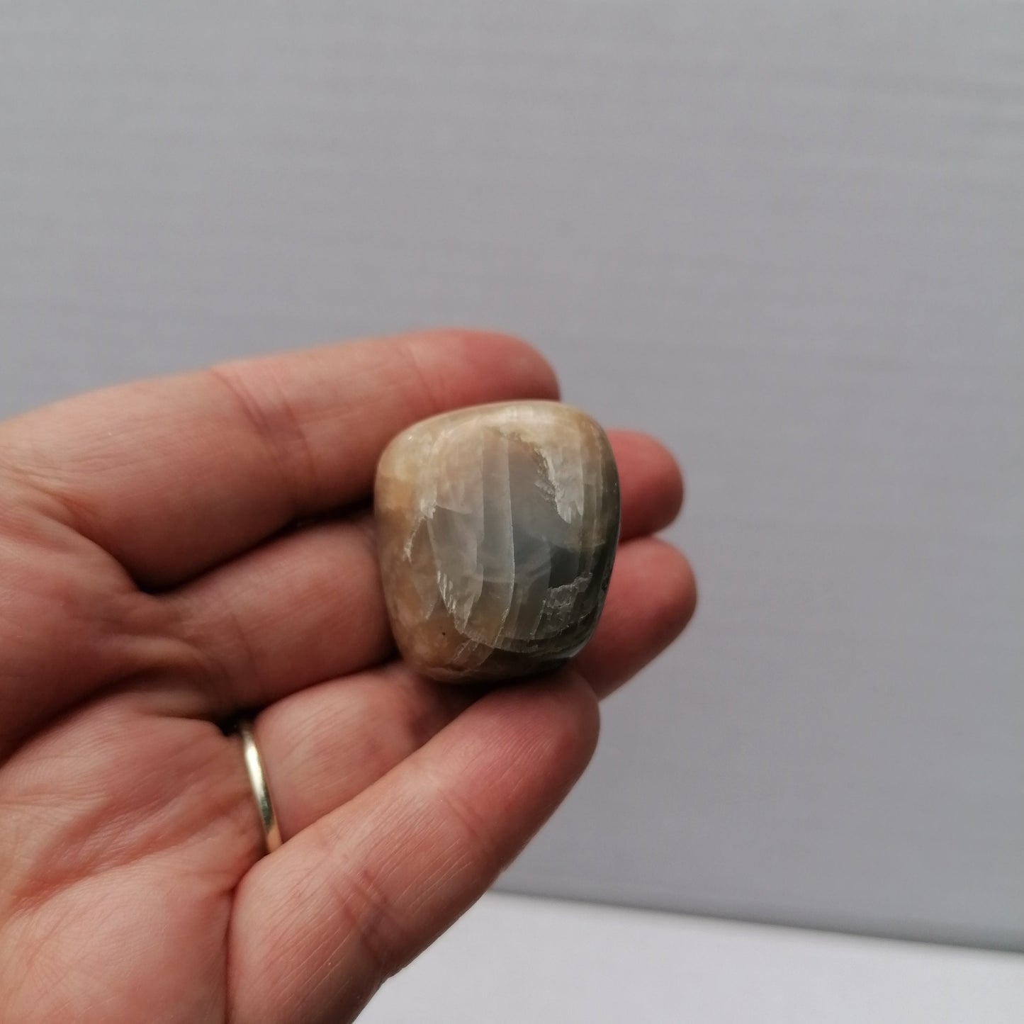 black moonstone tumble held in hand