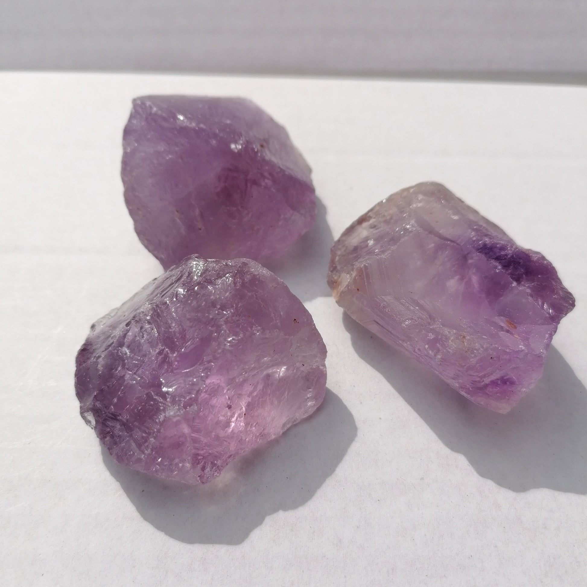 three pieces of natural raw purple amethyst