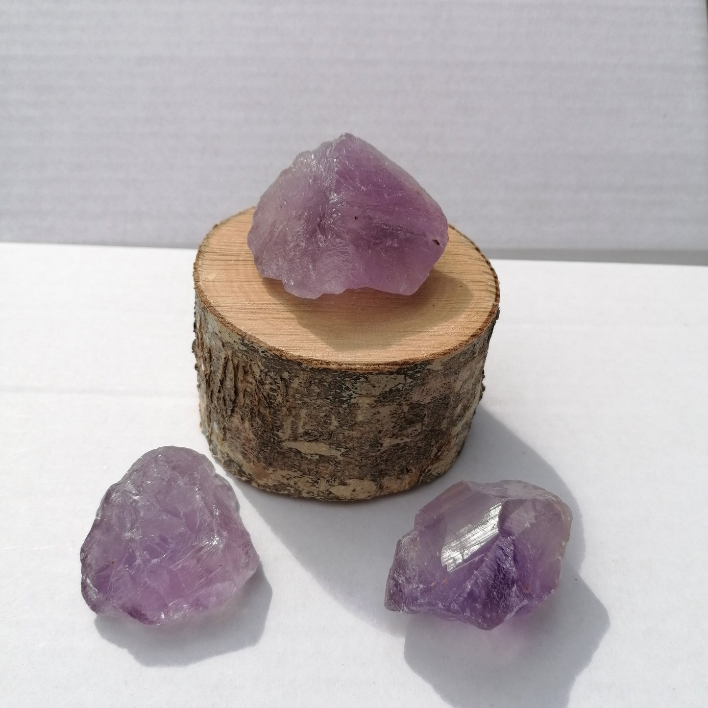 three large pieces of purple rough amethyst