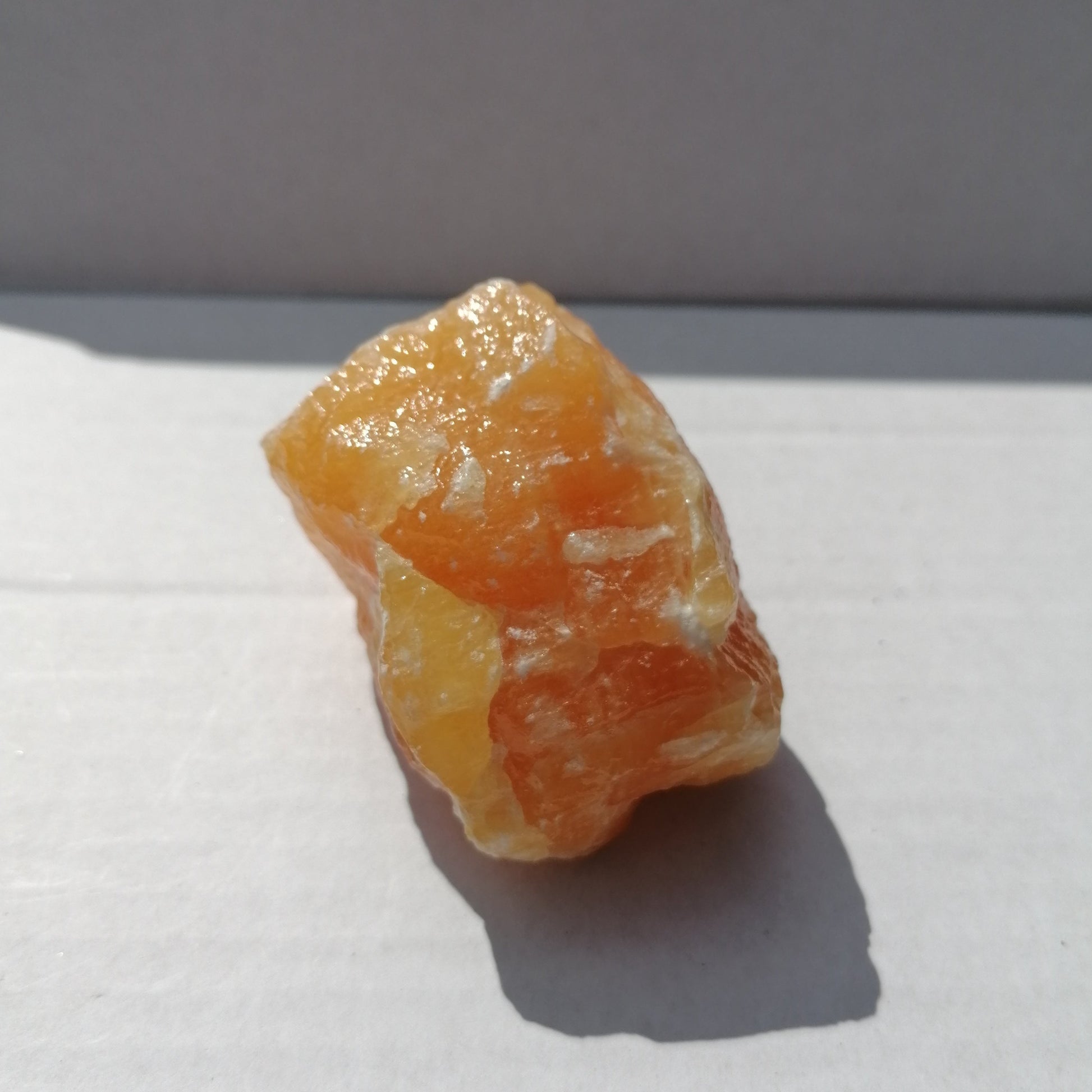 close up of a large raw chunk of orange calcite