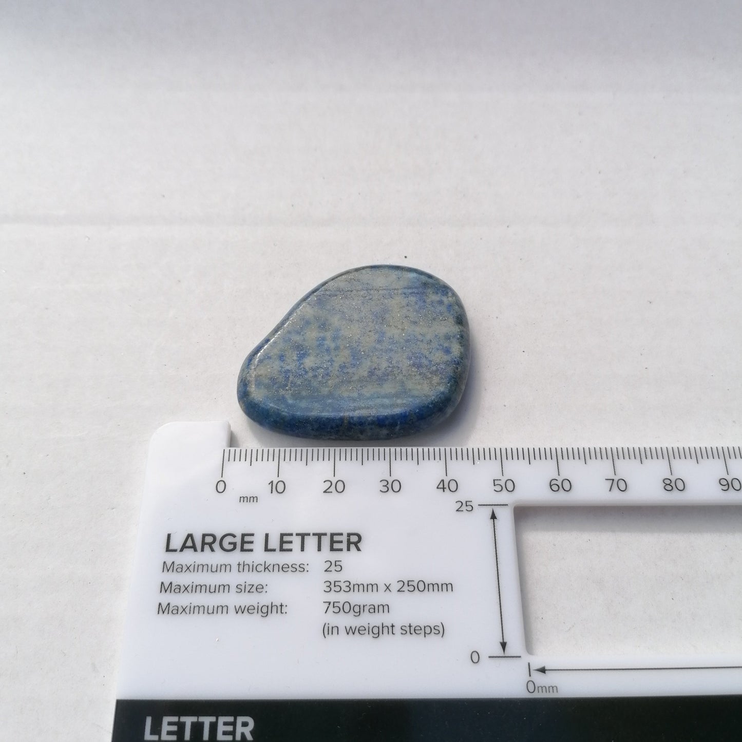 blue lapis lazuli smoothstone next to ruler 40mm