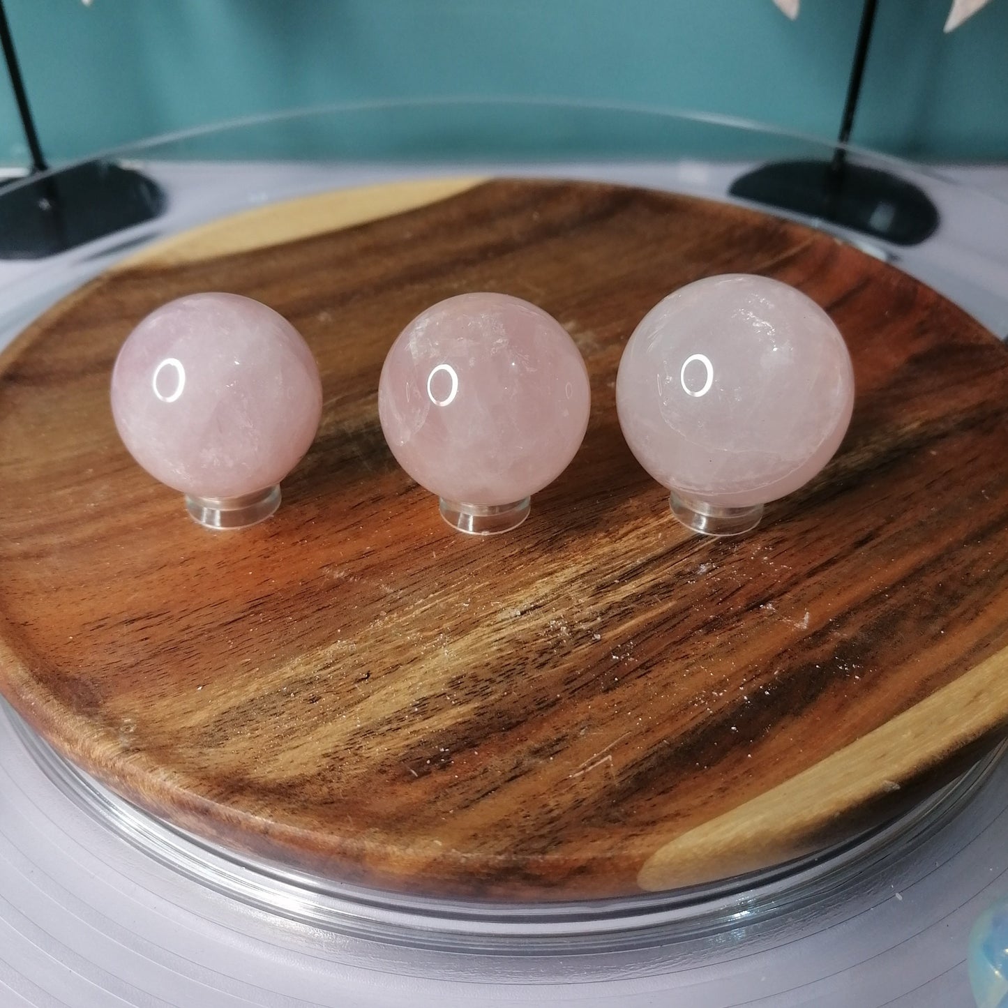 three pink Rose Quartz Spheres on stands