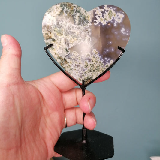 green and grey moss agate heart on stand