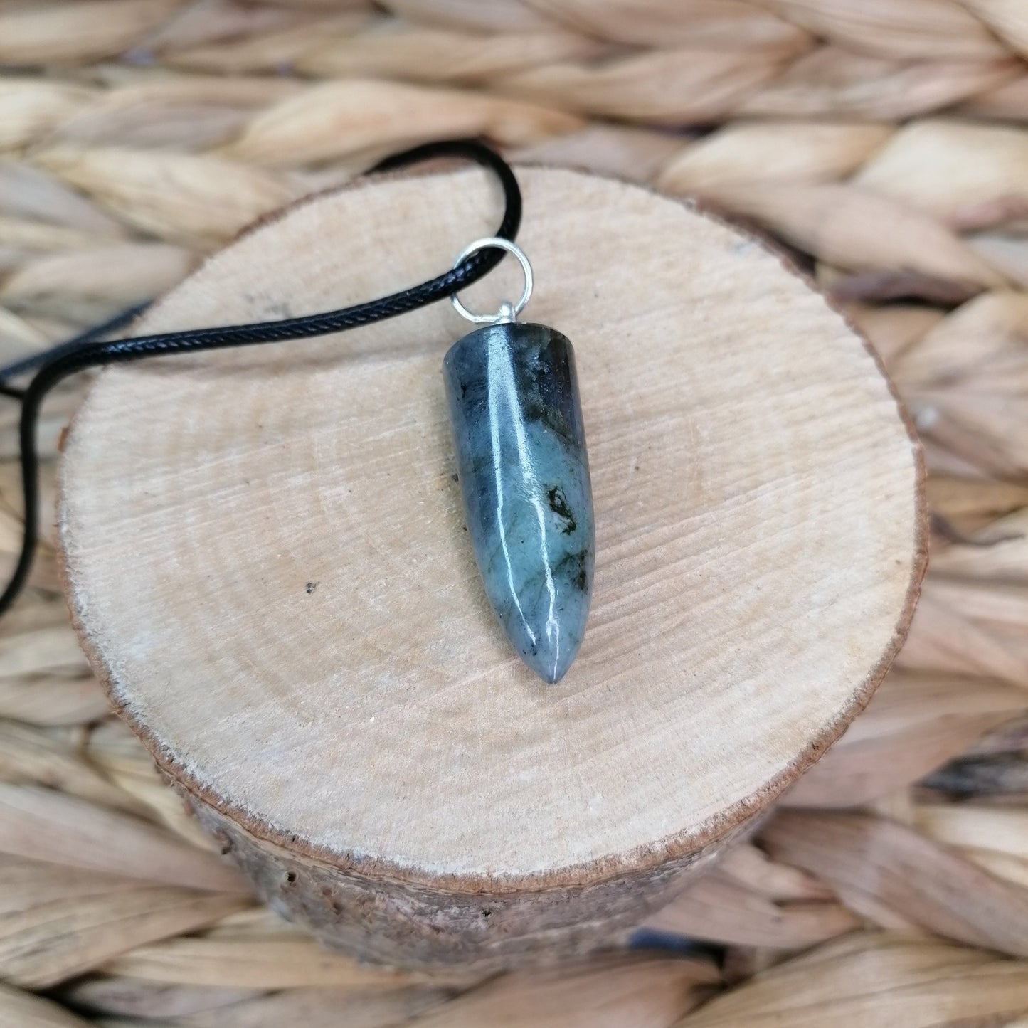 green and grey labradorite crystal bullet point necklace on a black chord chain