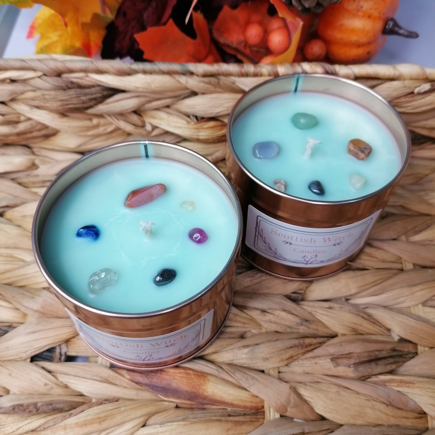 Blue candle in a rose gold tin with a Nerloni Portifino scent decorated with mixed chip crystals