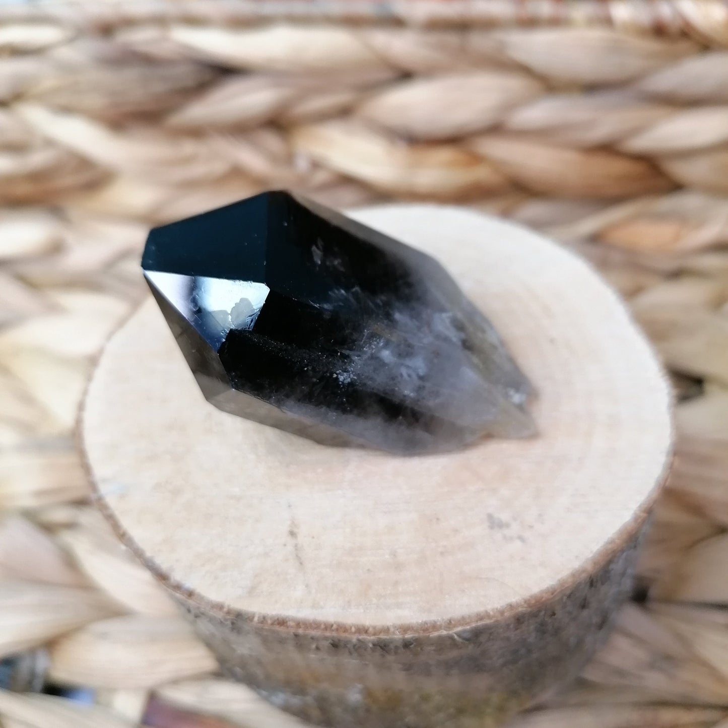 side view of the chunky smokey quartz point showing a darker point and whiter base