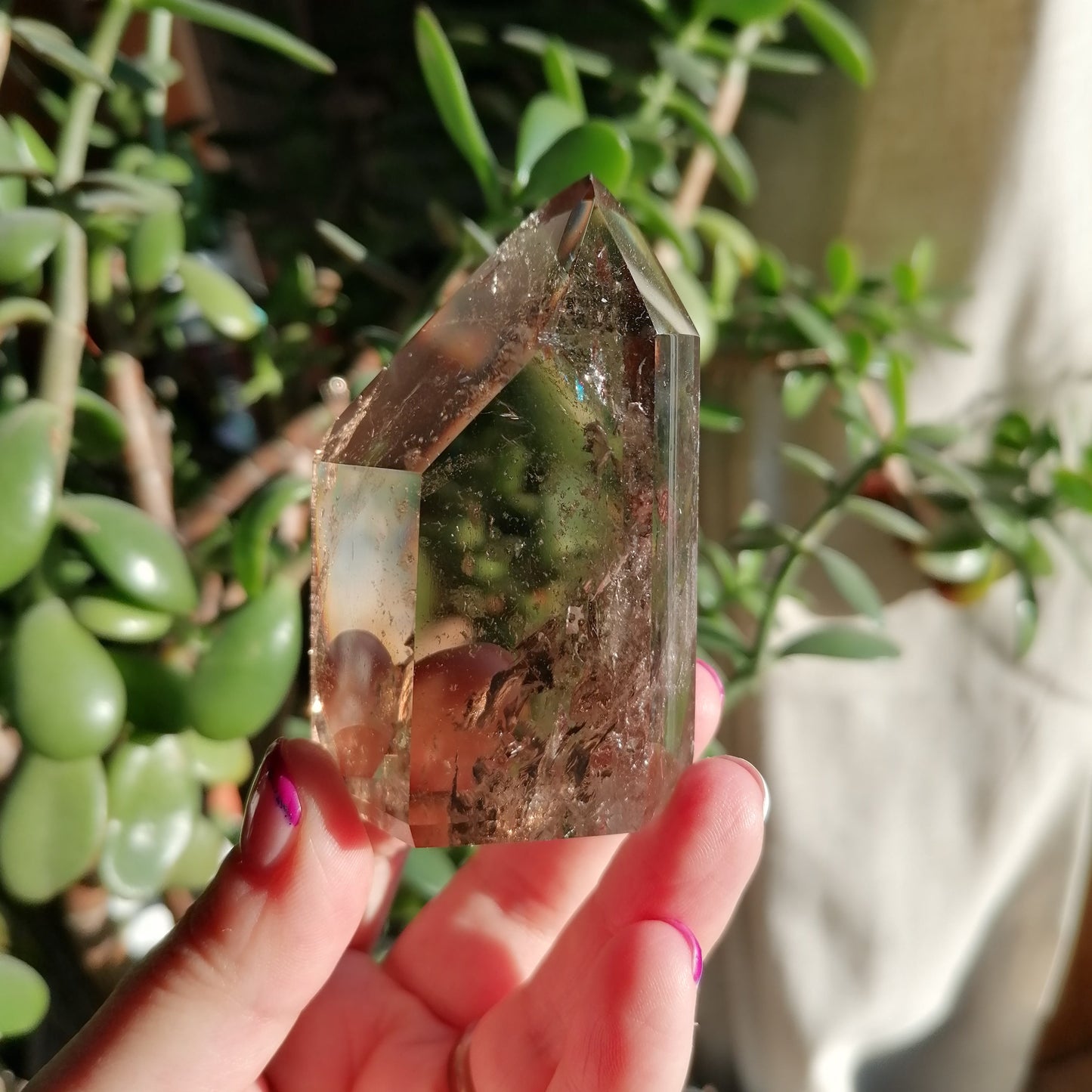 Brown smokey quartz tower with flashy rainbows