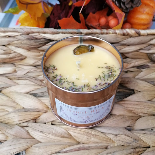 Spiced orange crystal candle in a rose gold tin. With orange wax this festive candle is decorated with a tigers eye crystal and scottish heather