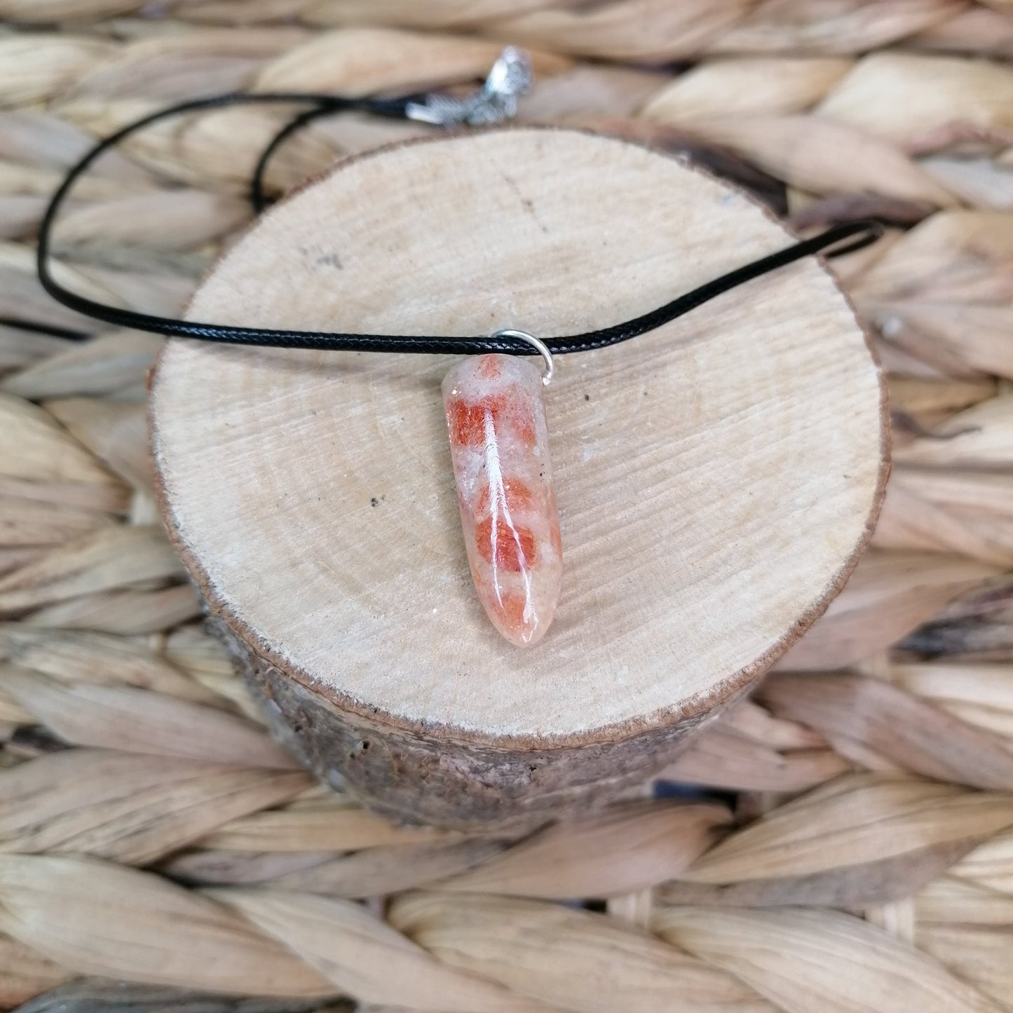 Orange Crystal Sunstone bullet point necklace on a black chord chain