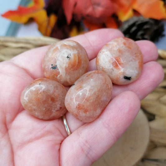 orange sunstone crystal tumbles with orange sparkly flash