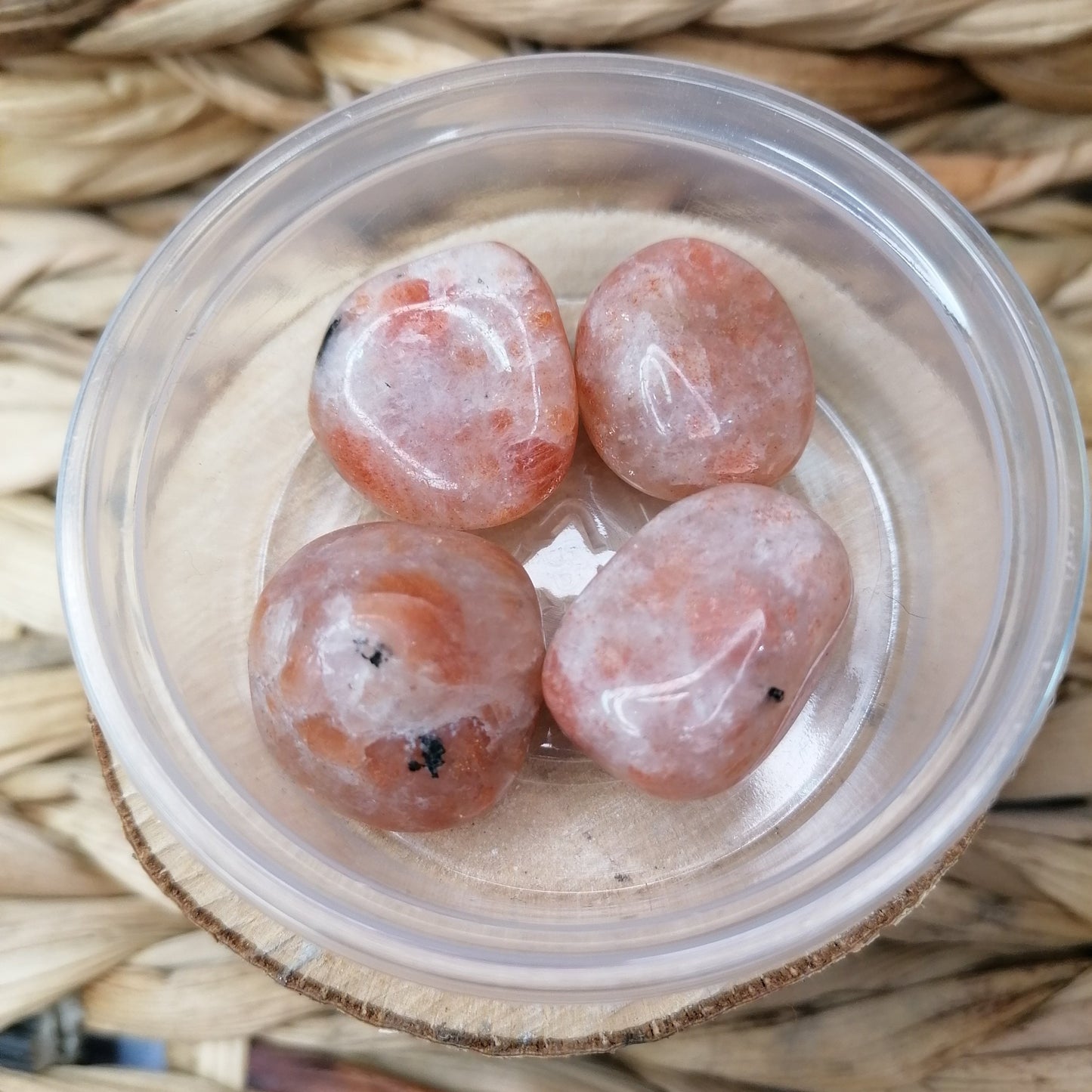 Sunstone Tumbles are orange with a sparkly orange flash with white and black inclusions