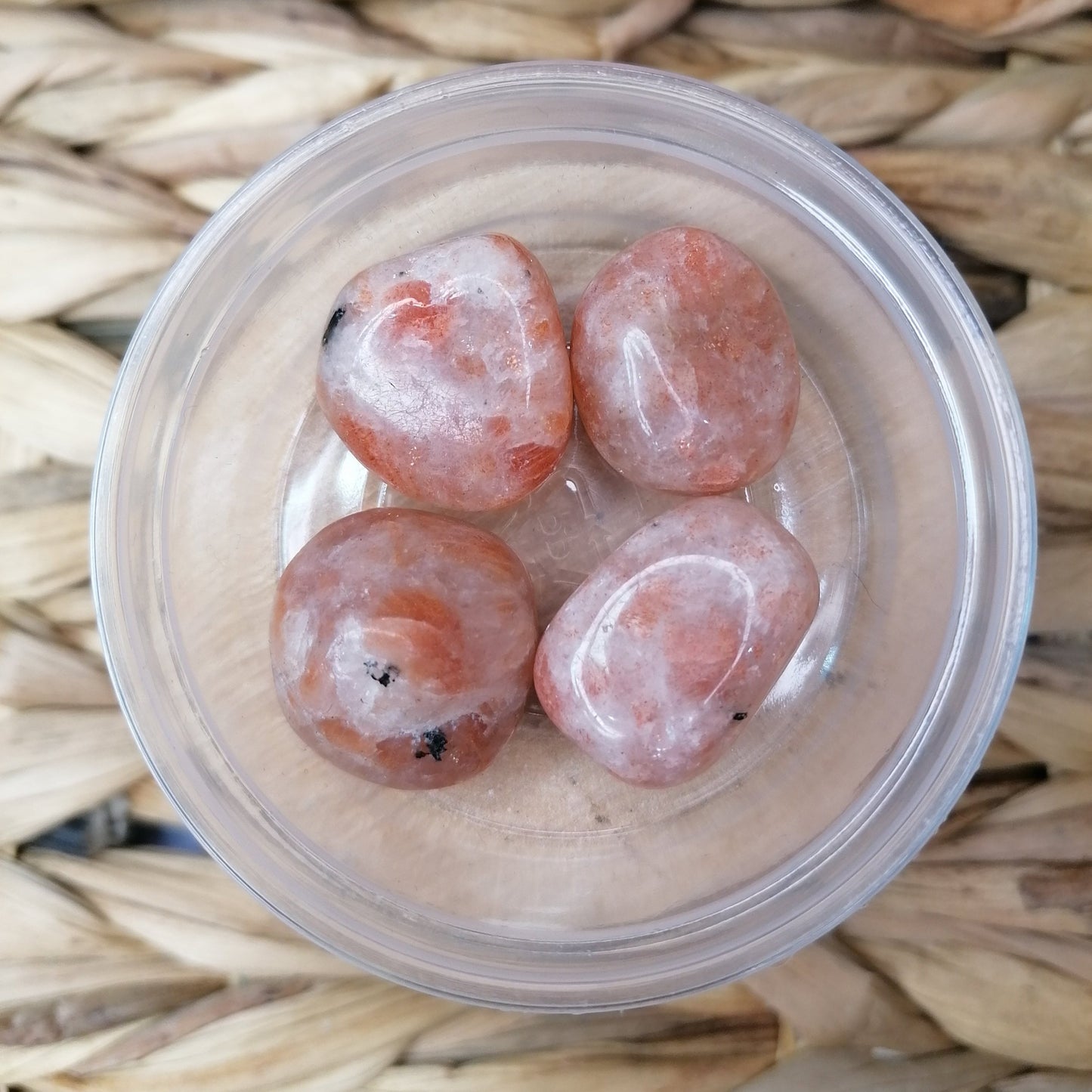 Orange Sunstone Tumblestones with shte and black inclusions and an orange sparkly flash