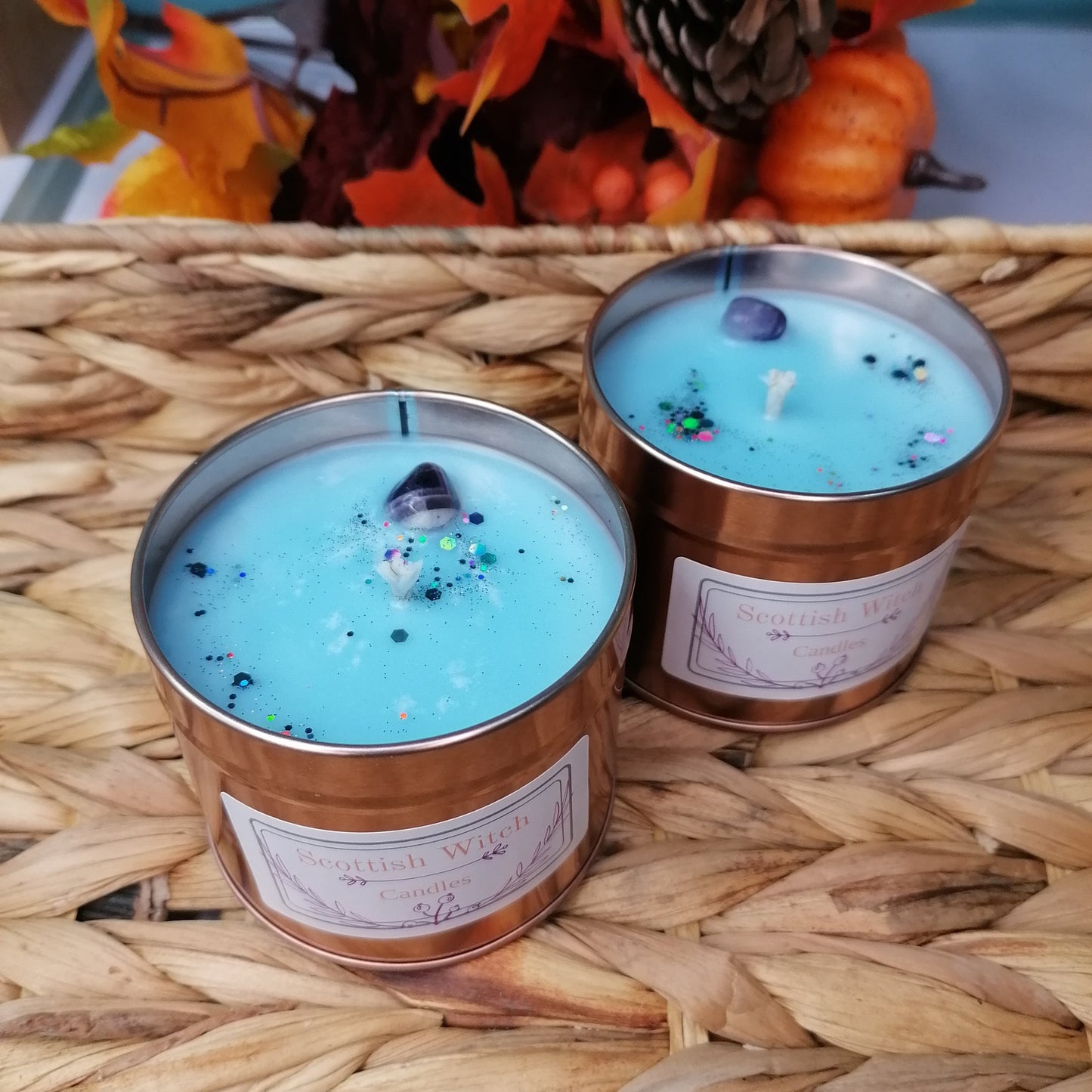 White Winter Scented Candle with Blue wax in a rose gold tin decorated with an amethyst crystal and glitter