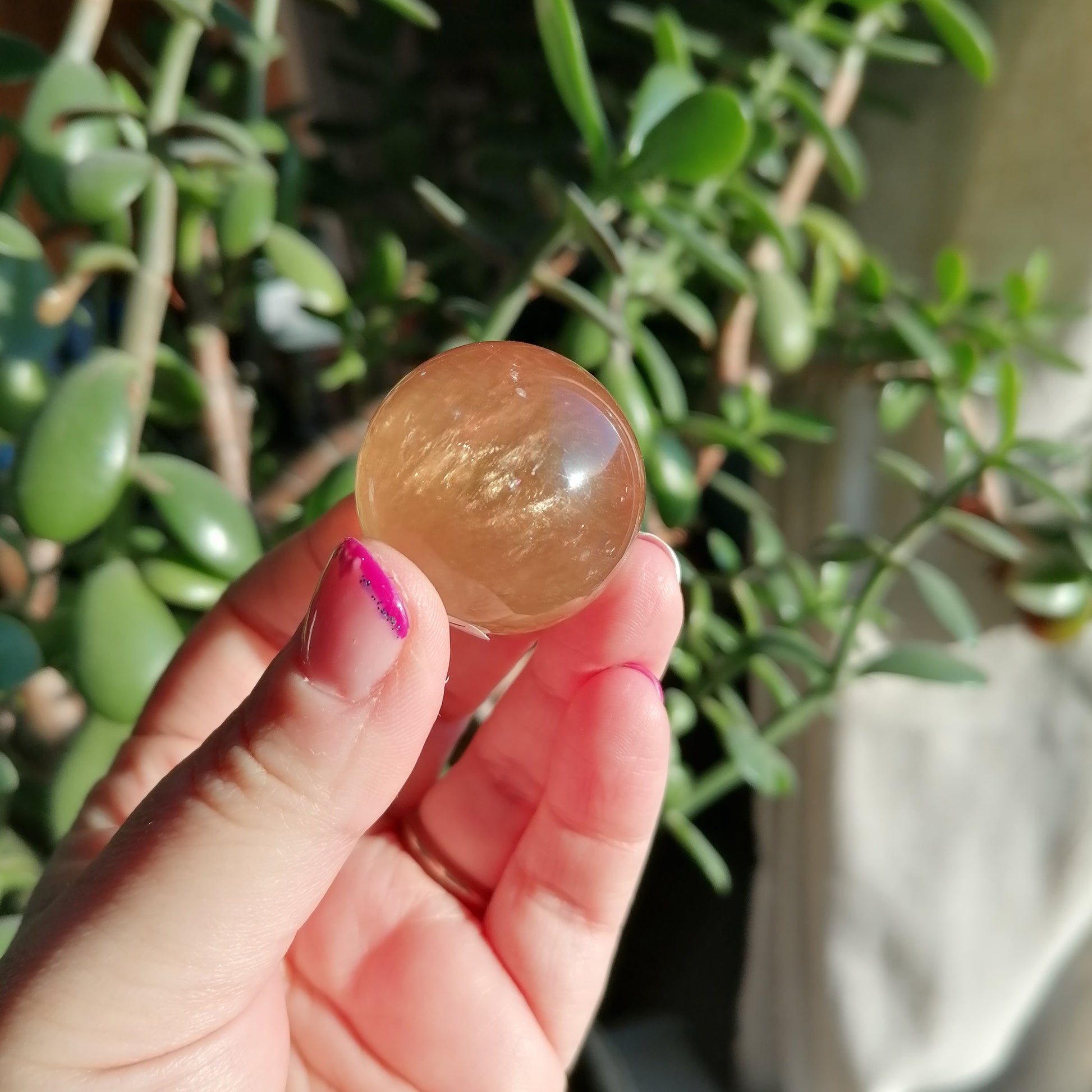 golden honey optical calcite sphere with rainbows, flashes and asterisms