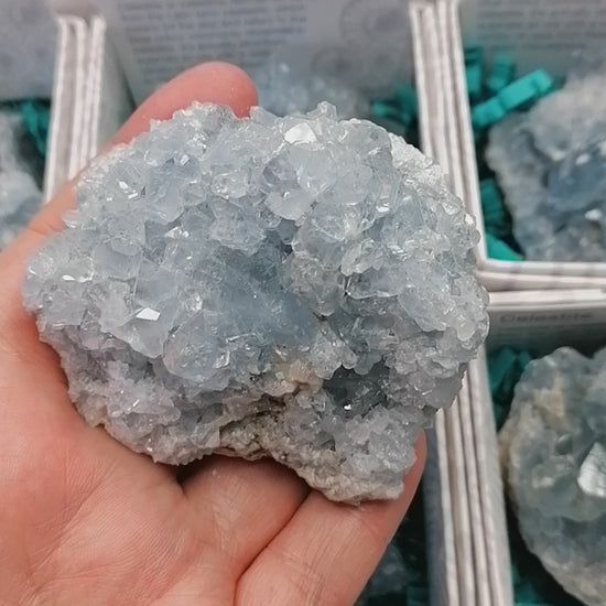 a video of a blue druzy celestite cluster sparkling in the light as it moves