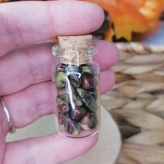 dragon stone crystal chips in a glass bottle