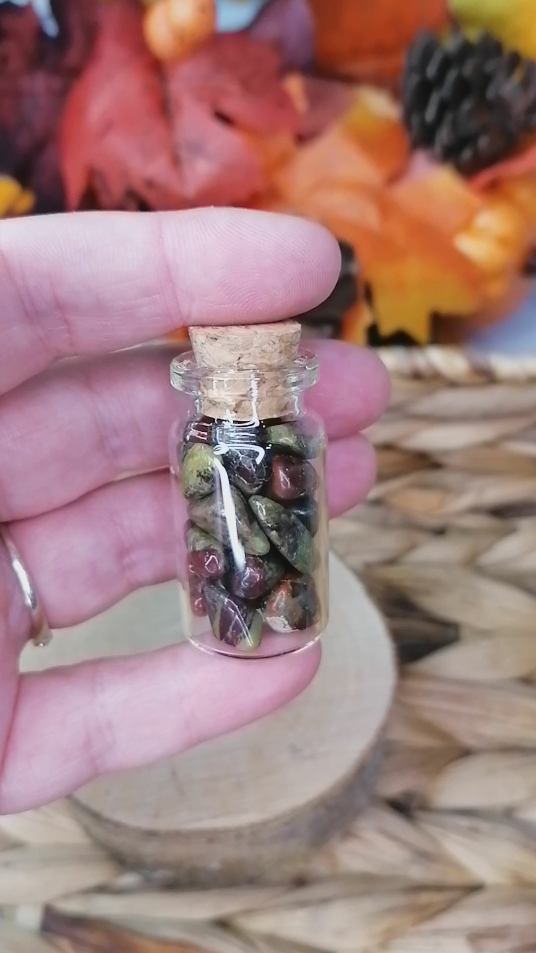 dragon stone crystal chips in a glass bottle