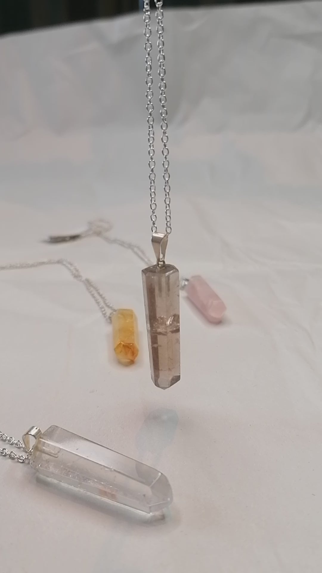 smokey quartz crystal point necklace on silver chain moving in the light